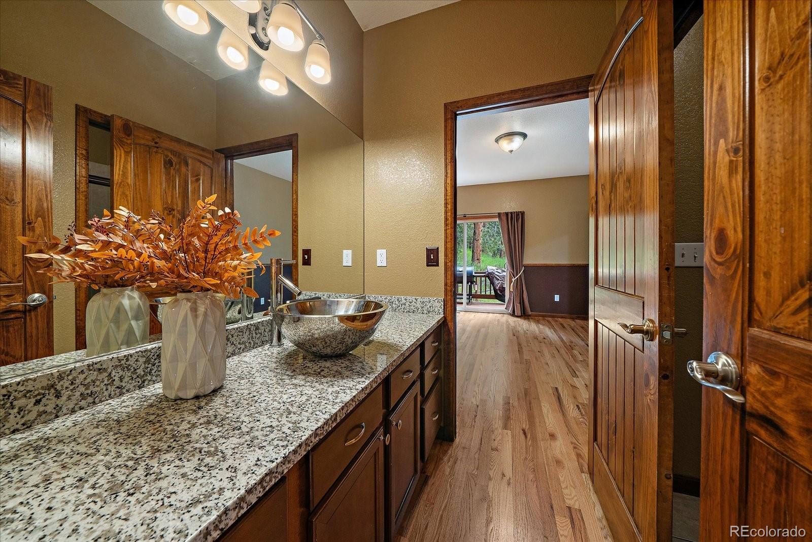 27756 Troublesome Gulch Road Evergreen, CO 80439 - Photo 22 of 47 a kitchen with sink and mirror