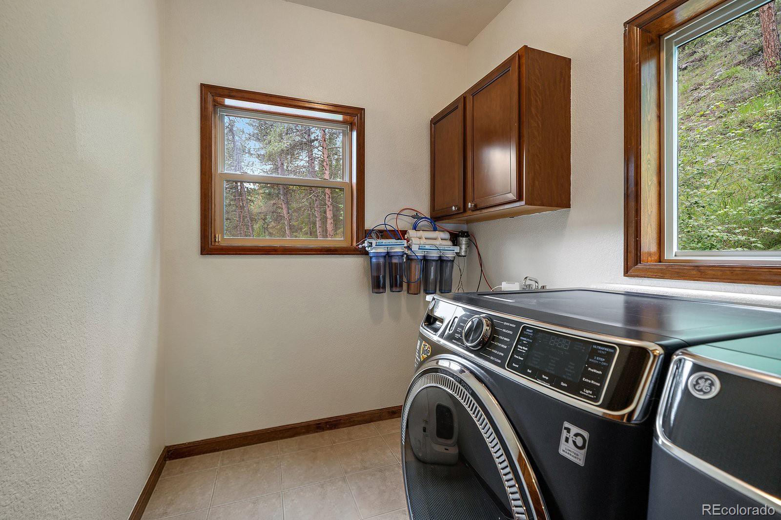 27756 Troublesome Gulch Road Evergreen, CO 80439 - Photo 23 of 47 a utility room with dryer and washer