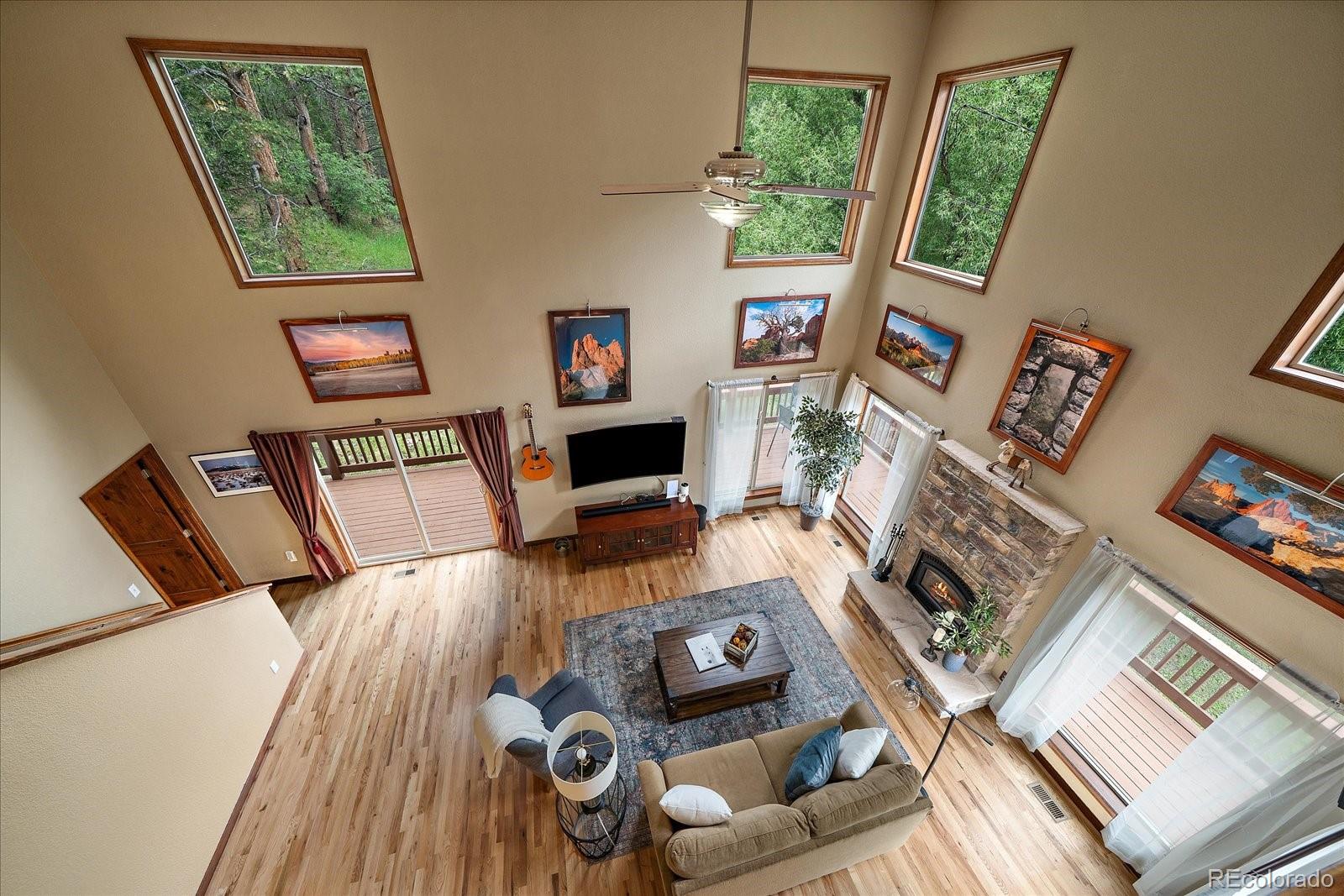 27756 Troublesome Gulch Road Evergreen, CO 80439 - Photo 24 of 47 a living room with furniture and a flat screen tv
