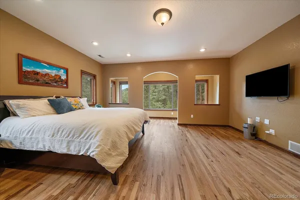 a bedroom with a large bed and a large window