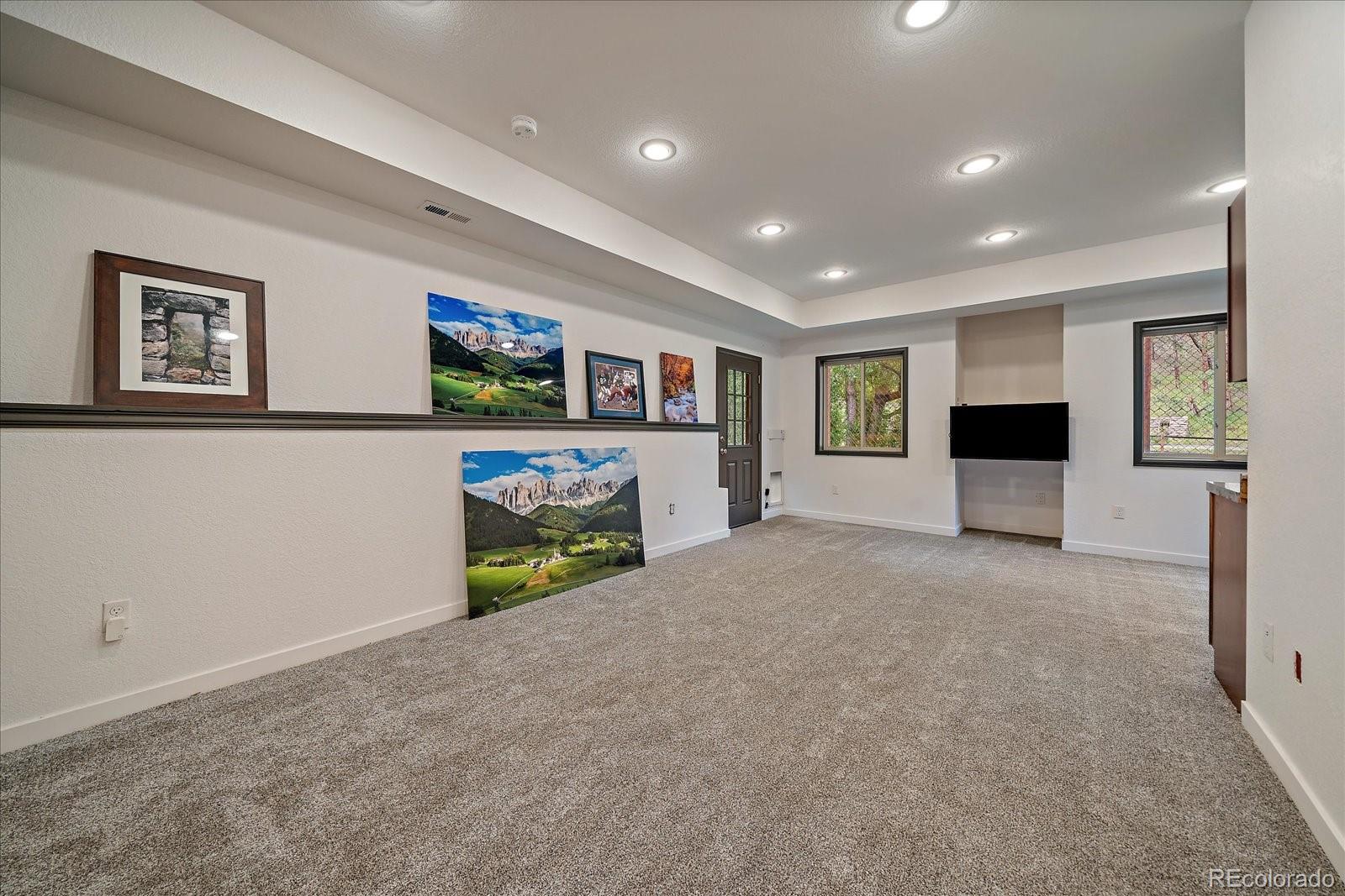 27756 Troublesome Gulch Road Evergreen, CO 80439 - Photo 32 of 47 a view of a livingroom with an empty space and a fireplace