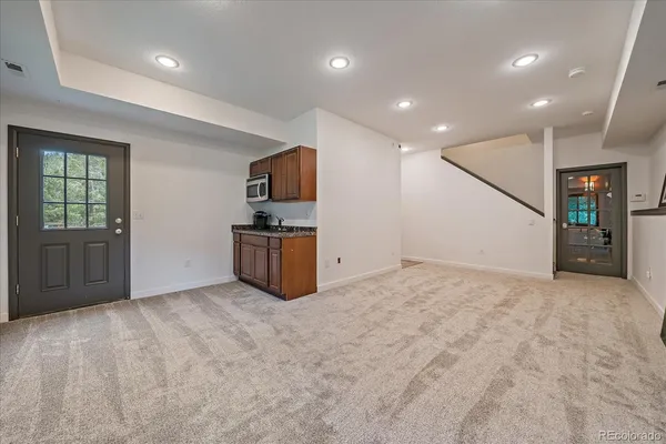 a view of kitchen with microwave and cabinets