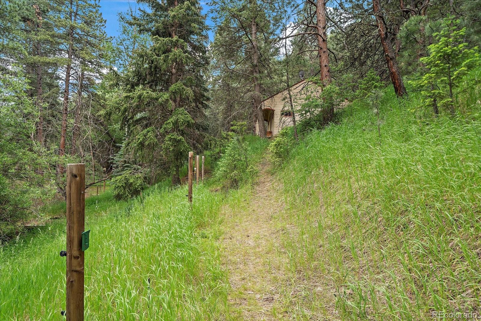 27756 Troublesome Gulch Road Evergreen, CO 80439 - Photo 36 of 47 a balcony with trees in front of it
