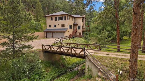 a view of house with outdoor space and sitting area