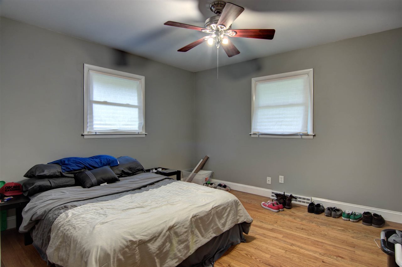 5981 Whitecliff Road Rockford, IL 61109 - Photo 12 of 25 a bedroom with a bed and a chandelier
