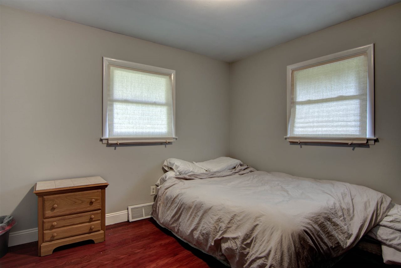 5981 Whitecliff Road Rockford, IL 61109 - Photo 14 of 25 a bed sitting in a bedroom next to a window