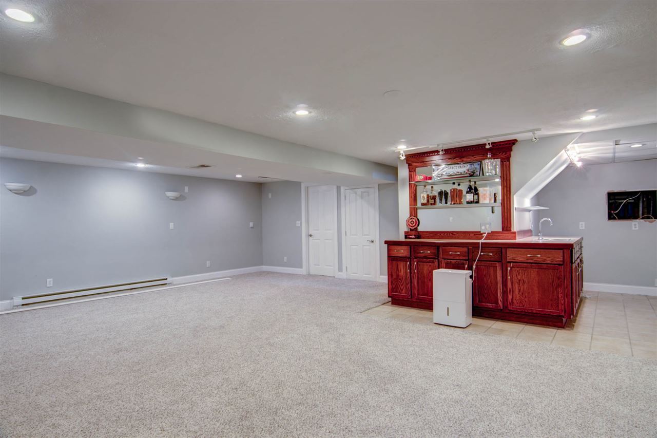 5981 Whitecliff Road Rockford, IL 61109 - Photo 20 of 25 a large room with chandelier and a wooden floors
