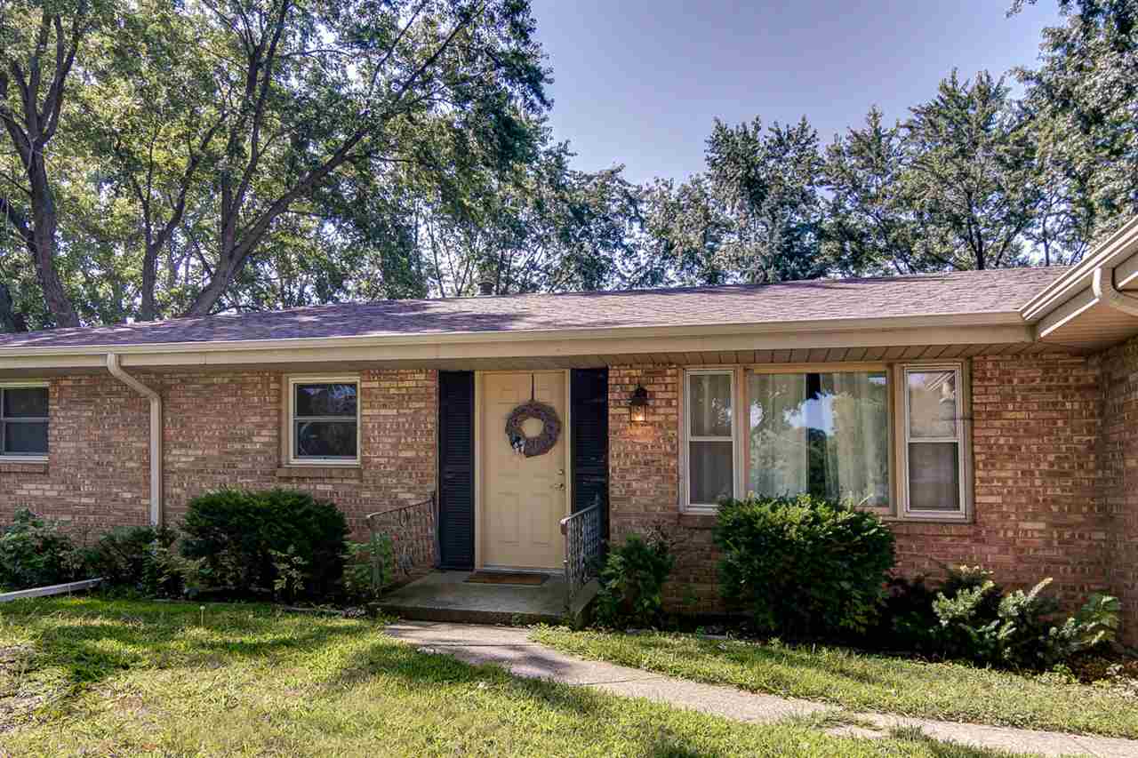 5981 Whitecliff Road Rockford, IL 61109 - Photo 2 of 25 a front view of a house with garden