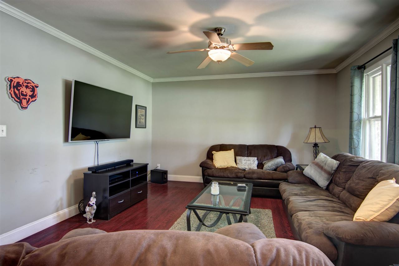 5981 Whitecliff Road Rockford, IL 61109 - Photo 4 of 25 a living room with furniture and a flat screen tv