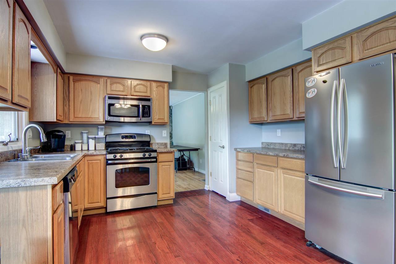 5981 Whitecliff Road Rockford, IL 61109 - Photo 8 of 25 a kitchen with stainless steel appliances a refrigerator stove and microwave