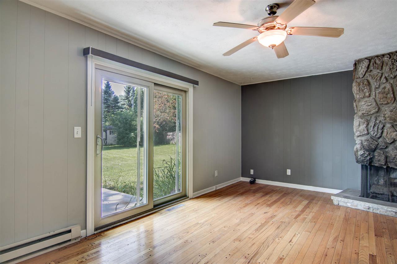 5981 Whitecliff Road Rockford, IL 61109 - Photo 9 of 25 an empty room with windows and ceiling fan