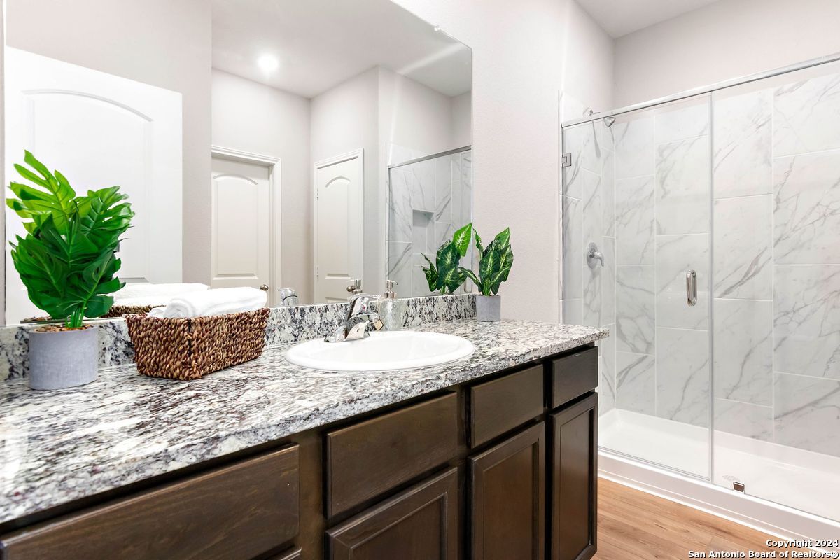 9219 Bennett Forest Converse, TX 78109 - Photo 14 of 23 a bathroom with a granite countertop sink and a mirror
