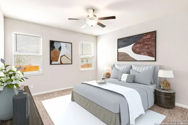 a bedroom with a bed and a painting on the wall