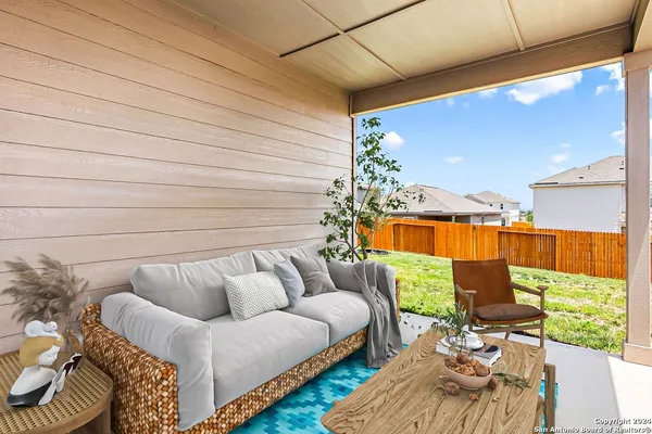 a roof deck with couches and potted plants