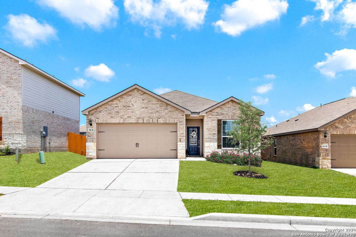 9219 Bennett Forest Converse, TX 78109 - Photo 2 of 23 a front view of a house with a yard and garage