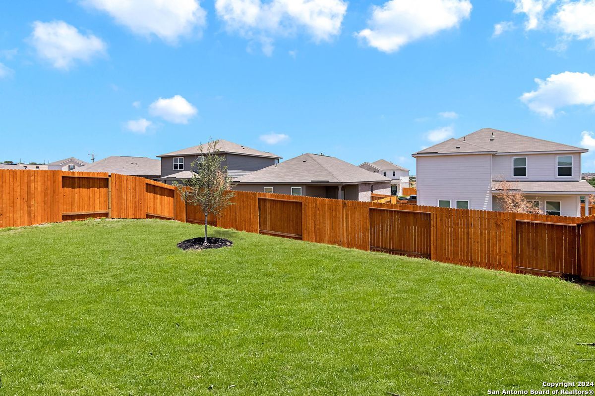9219 Bennett Forest Converse, TX 78109 - Photo 21 of 23 a view of a backyard with a garden and deck