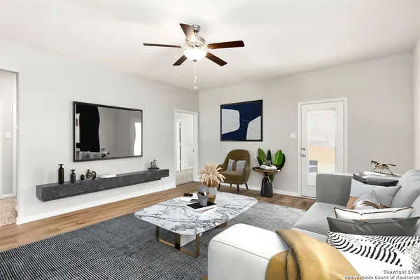 a living room with furniture and a wooden floor