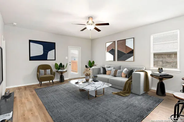 a living room with furniture and wooden floor