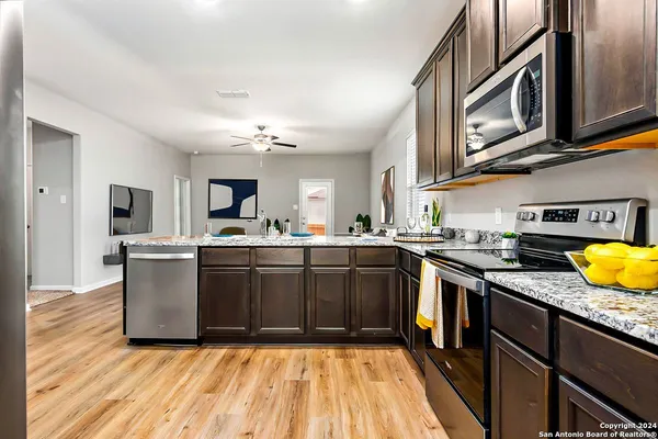 a kitchen with a sink cabinets and stainless steel appliances