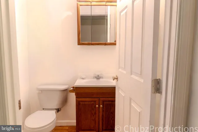 a bathroom with a sink a toilet and a mirror