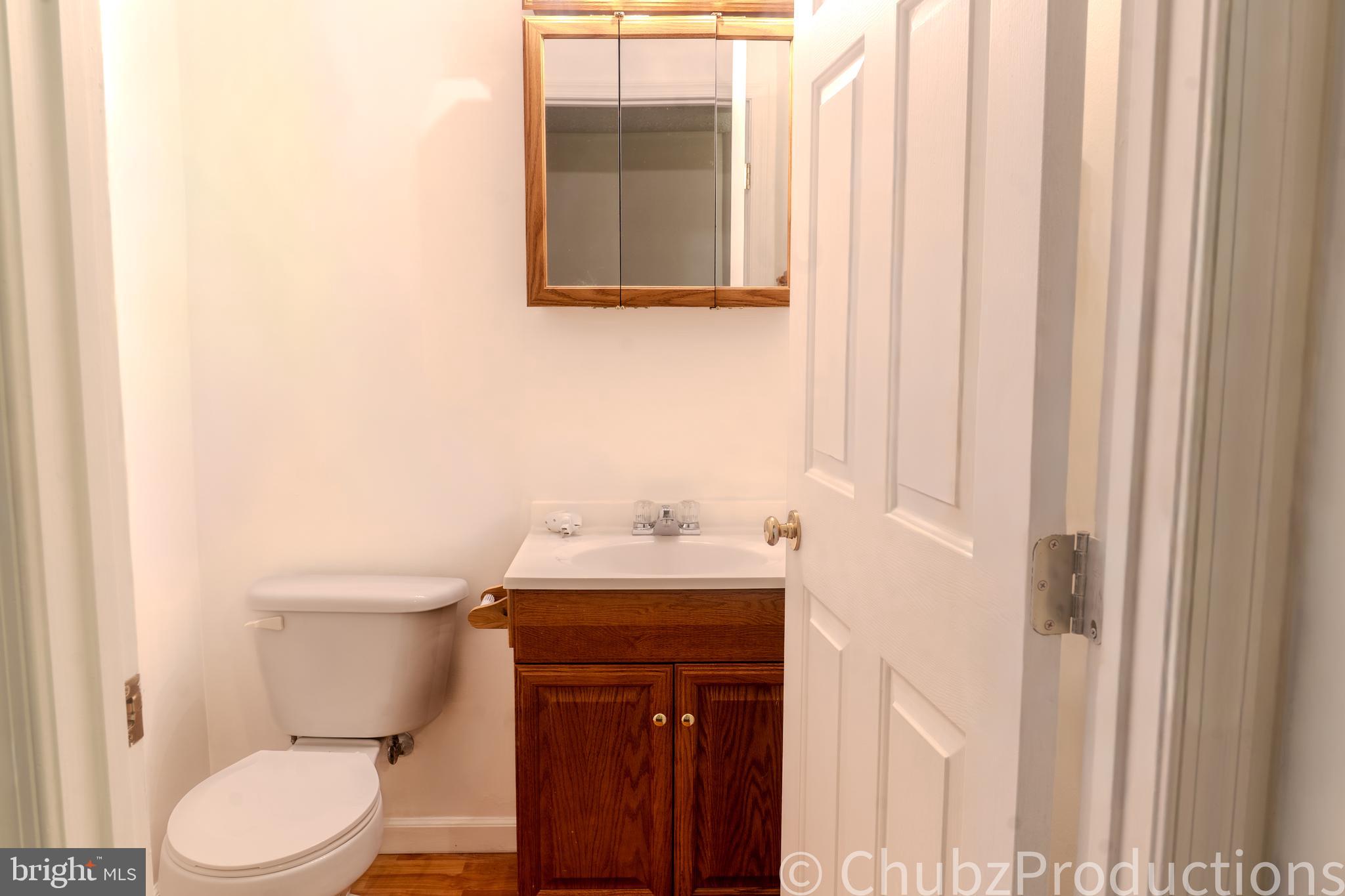 8316 Widgeon Place Laurel, MD 20724 - Photo 11 of 32 a bathroom with a sink a toilet and a mirror