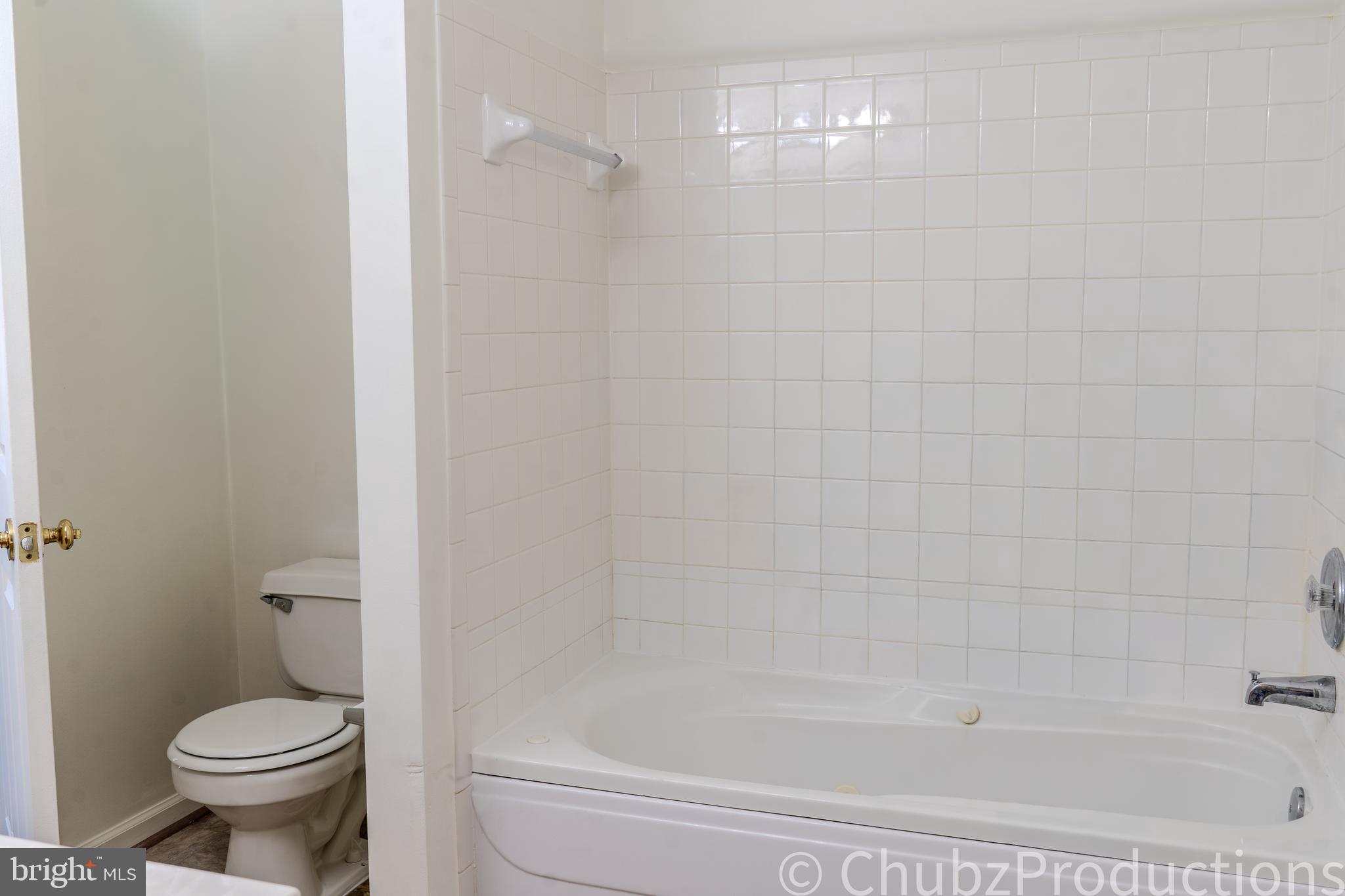 8316 Widgeon Place Laurel, MD 20724 - Photo 18 of 32 a bathroom with a shower and a toilet