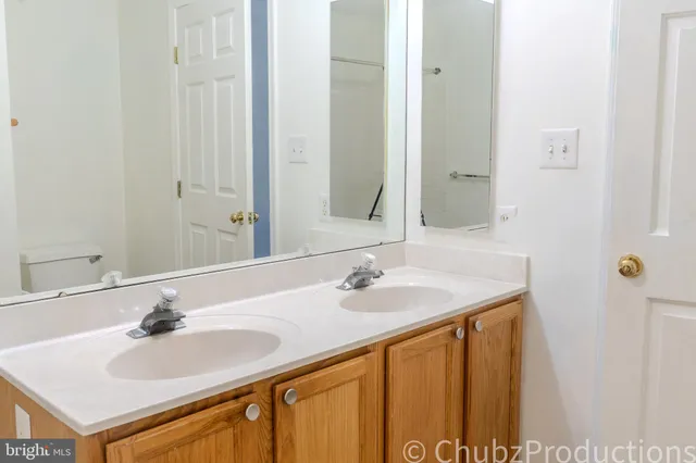 a view of a bathroom from a corridor