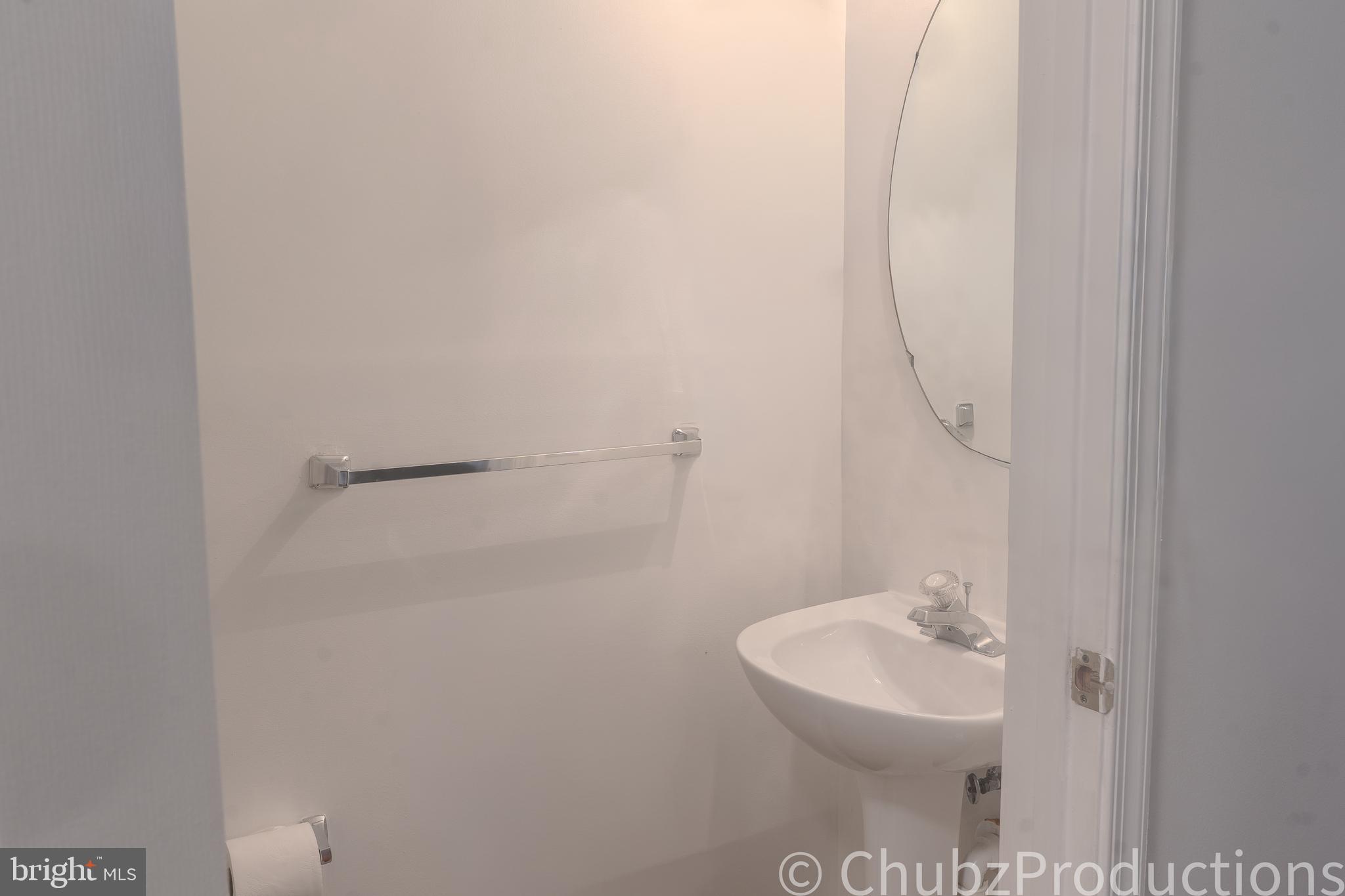 8316 Widgeon Place Laurel, MD 20724 - Photo 25 of 32 a bathroom with a sink a toilet and mirror