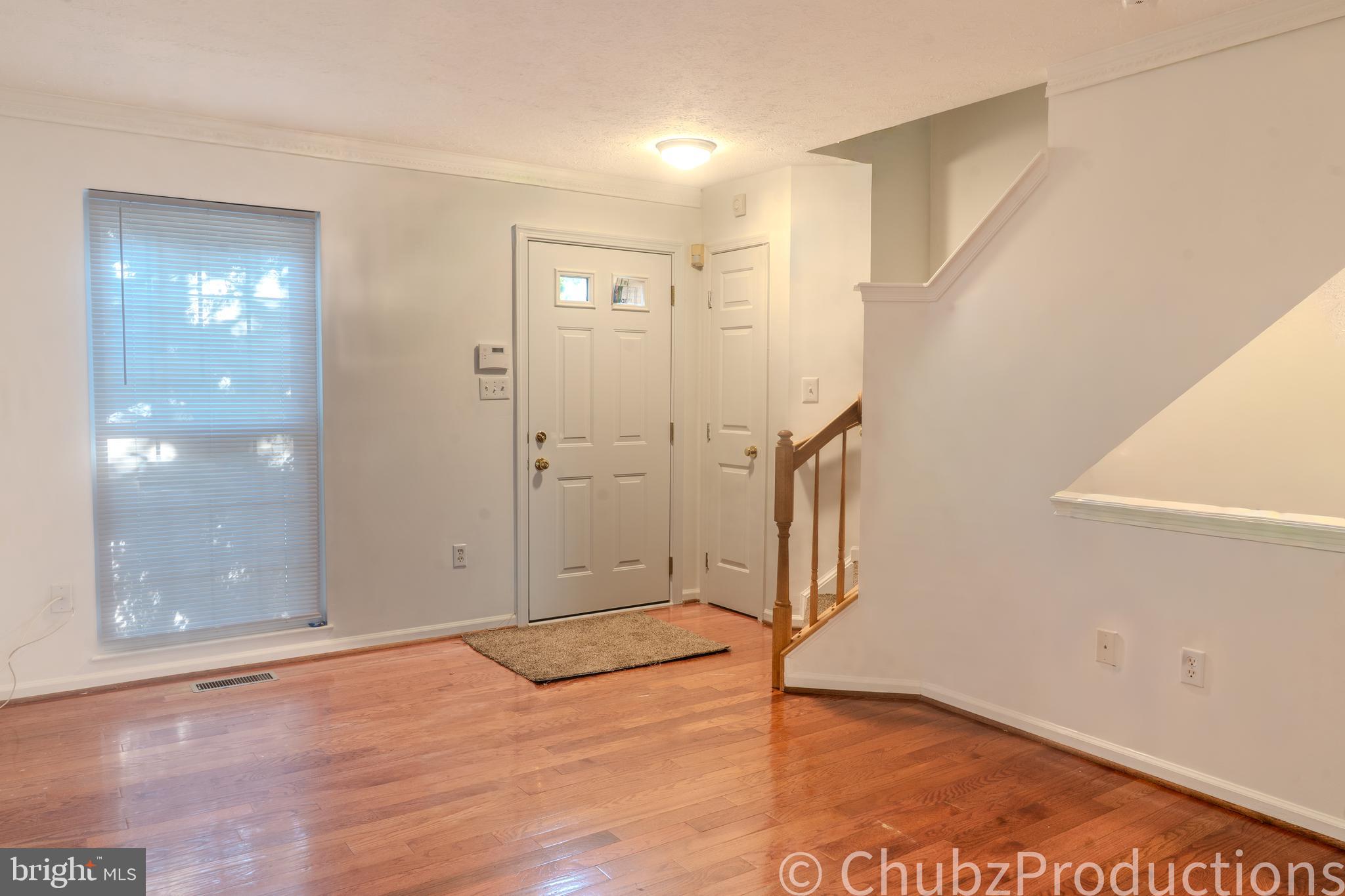 8316 Widgeon Place Laurel, MD 20724 - Photo 28 of 32 an empty room with wooden floor and door