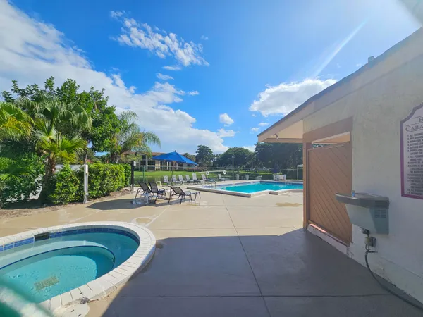 a swimming pool with outdoor seating and yard