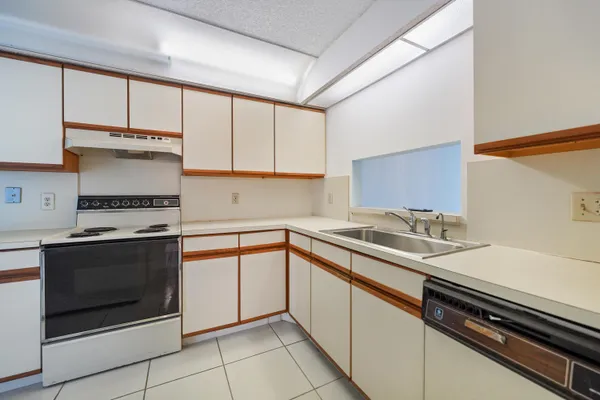 a kitchen with a sink stove and cabinets