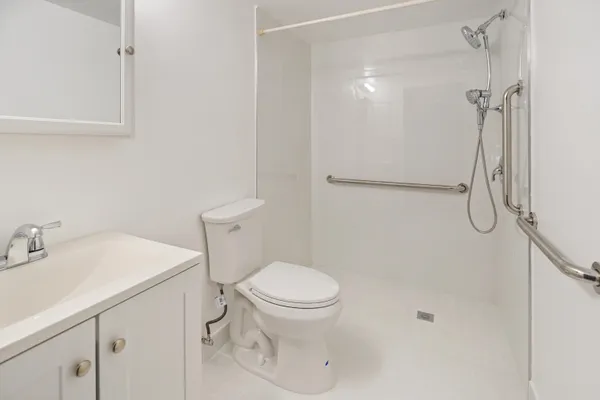 a bathroom with a sink toilet and shower