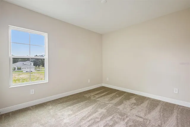 a view of an empty room and closet area