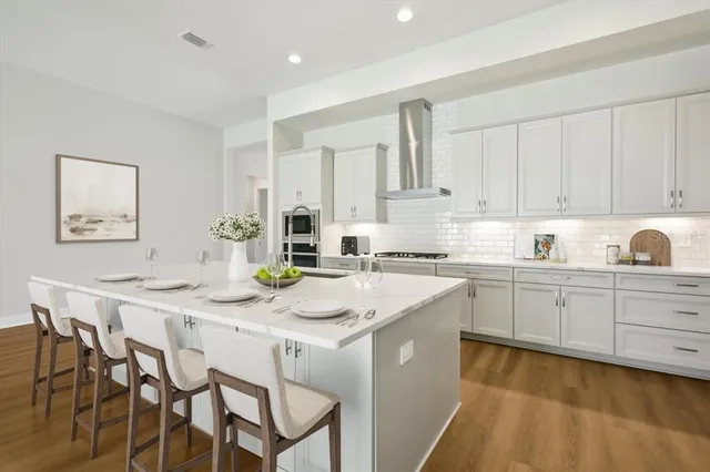 a kitchen with appliances a sink and cabinets
