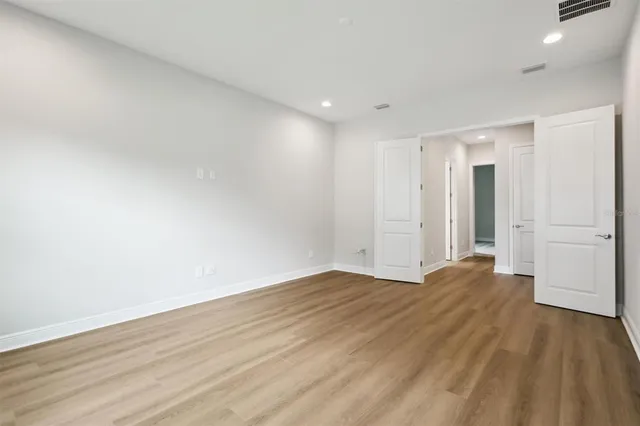 a view of an empty room with wooden floor