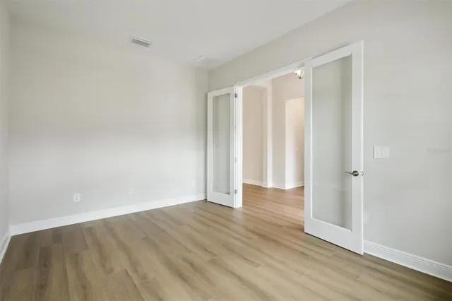 a view of room with wooden floor
