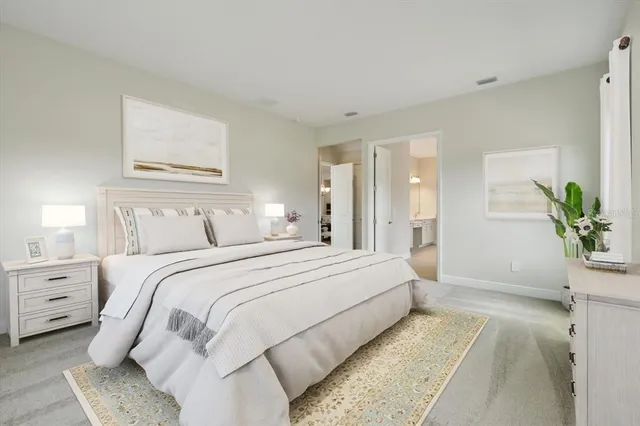 a spacious bedroom with a bed and a couch