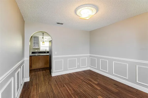 a view of room with hardwood floor and ceiling fan