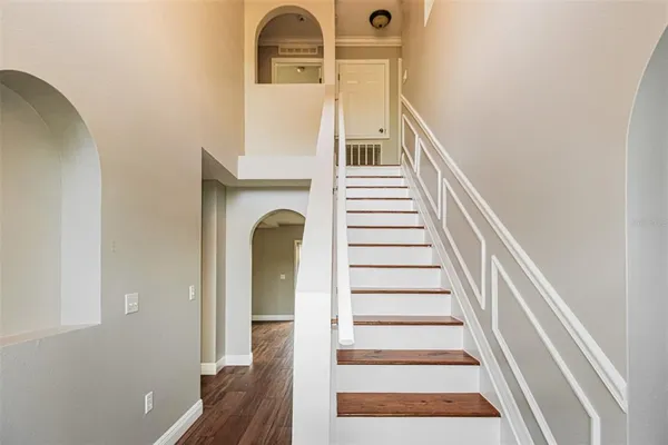a view of entryway and hall with wooden floor
