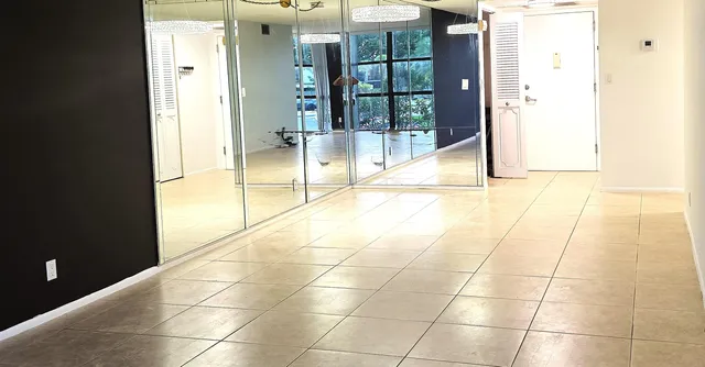 a view of a swimming pool with lawn chairs under an umbrella