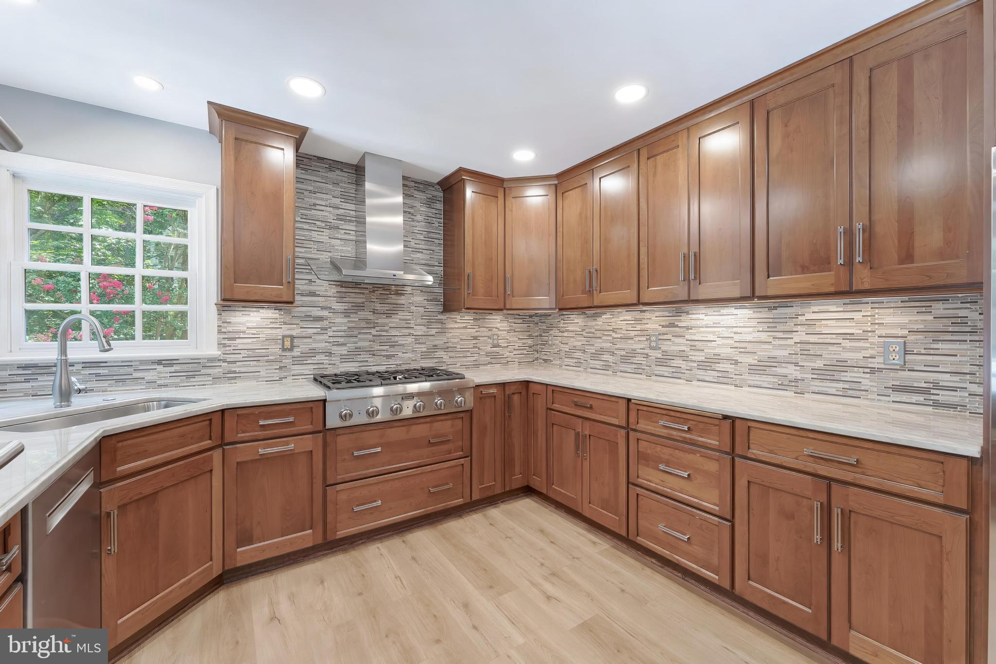 1248 Lamplighter Way Reston, VA 20194 - Photo 16 of 64 a kitchen with wooden cabinets and sink