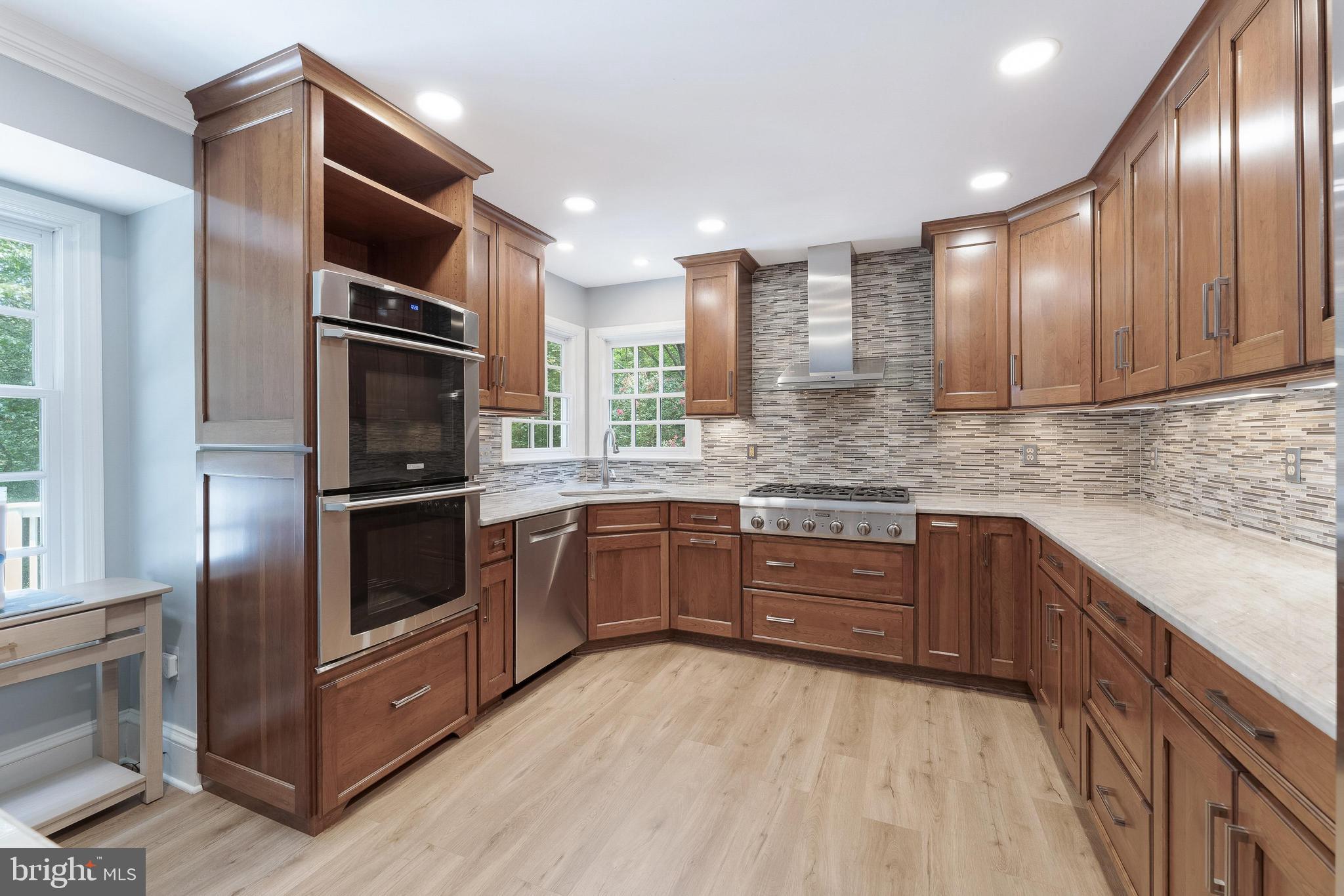 1248 Lamplighter Way Reston, VA 20194 - Photo 17 of 64 a kitchen with stainless steel appliances granite countertop a refrigerator and a stove top oven