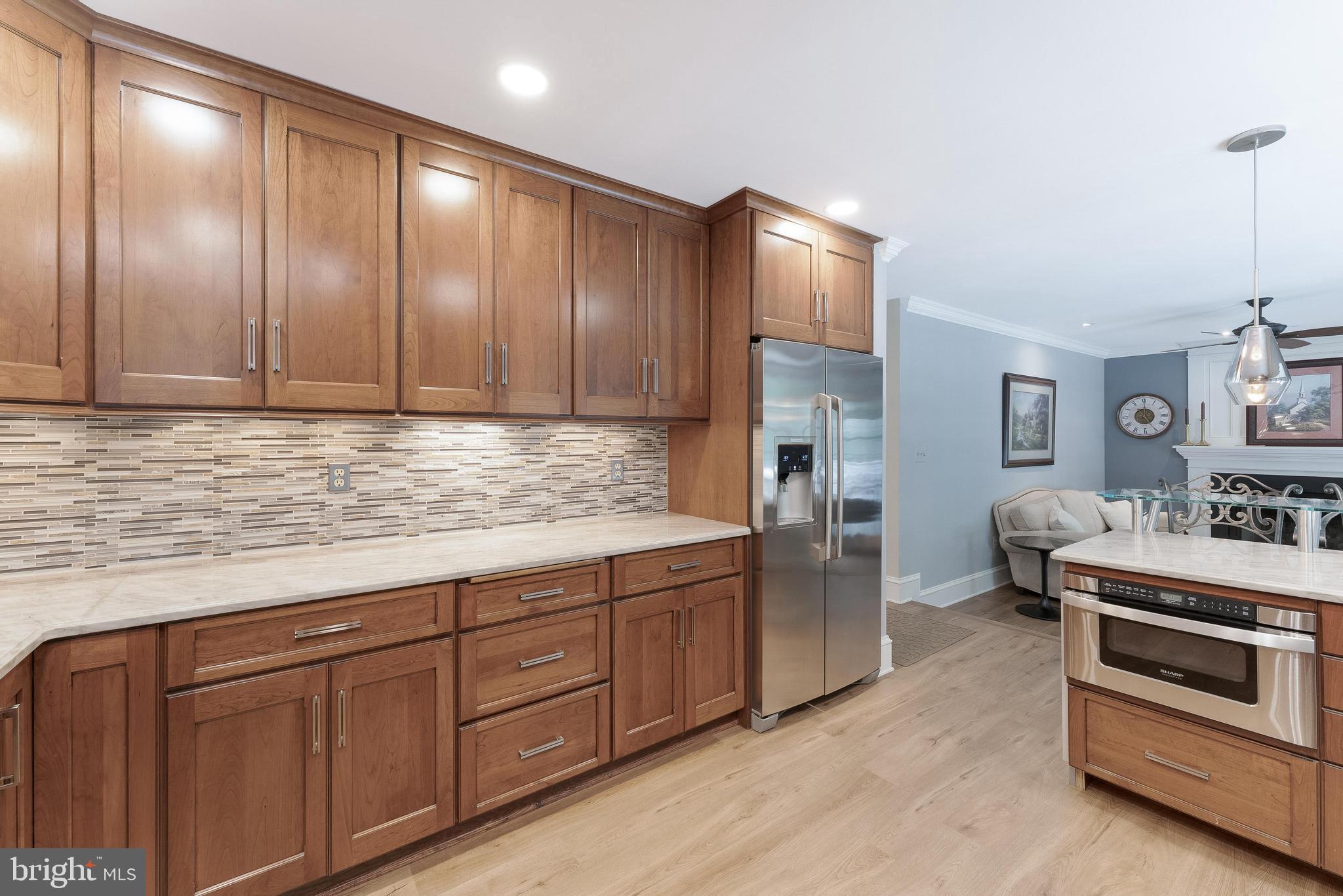 1248 Lamplighter Way Reston, VA 20194 - Photo 18 of 64 a kitchen with stainless steel appliances granite countertop a refrigerator and a stove top oven