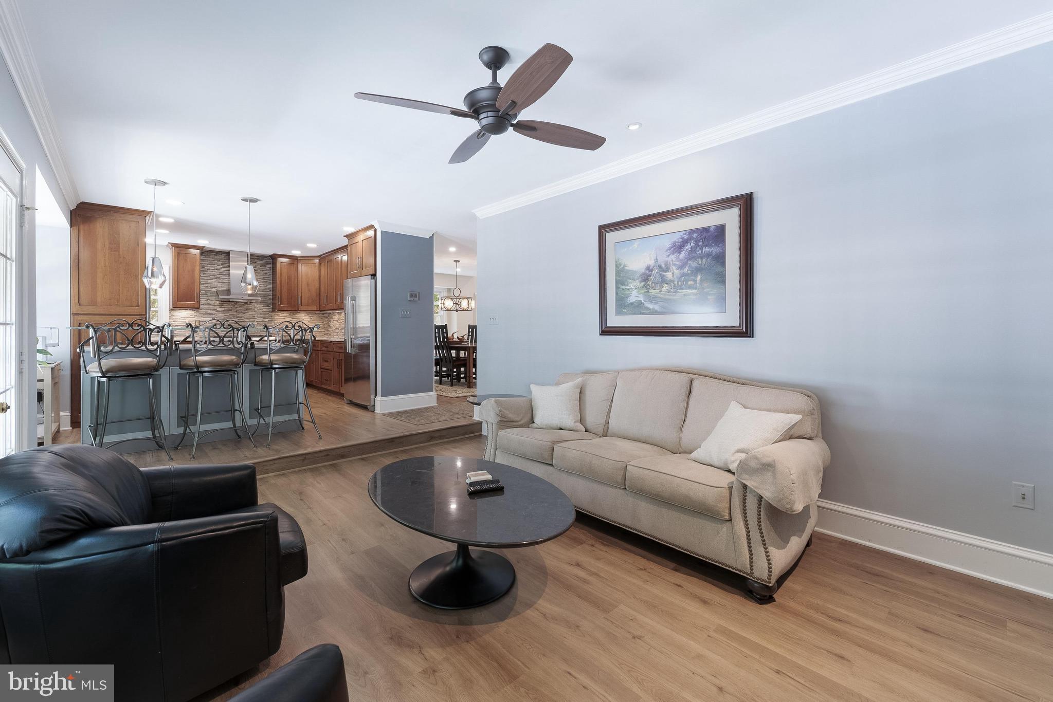 1248 Lamplighter Way Reston, VA 20194 - Photo 20 of 64 a living room with furniture and a view of kitchen