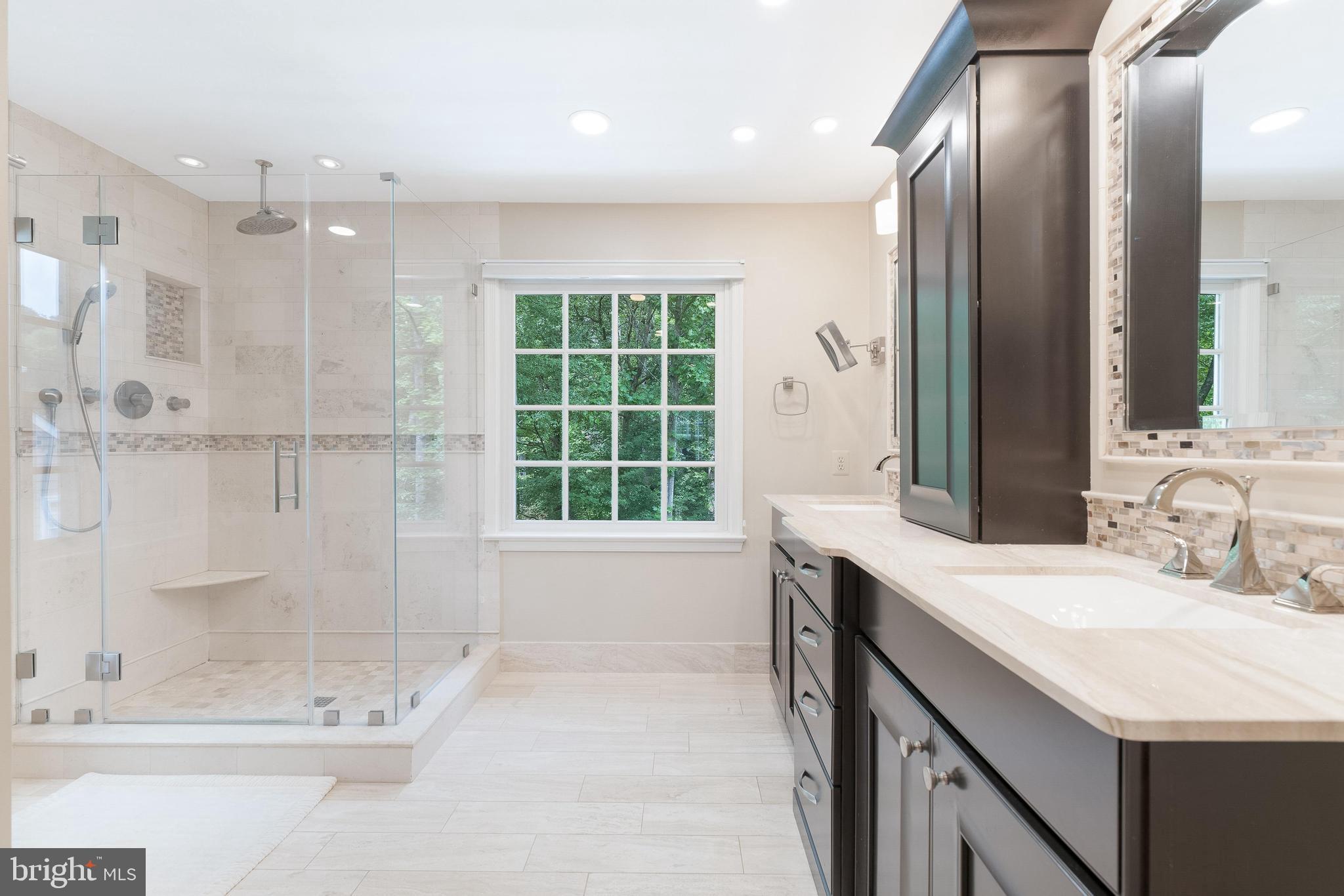 1248 Lamplighter Way Reston, VA 20194 - Photo 29 of 64 a bathroom with a double vanity sink mirror and shower