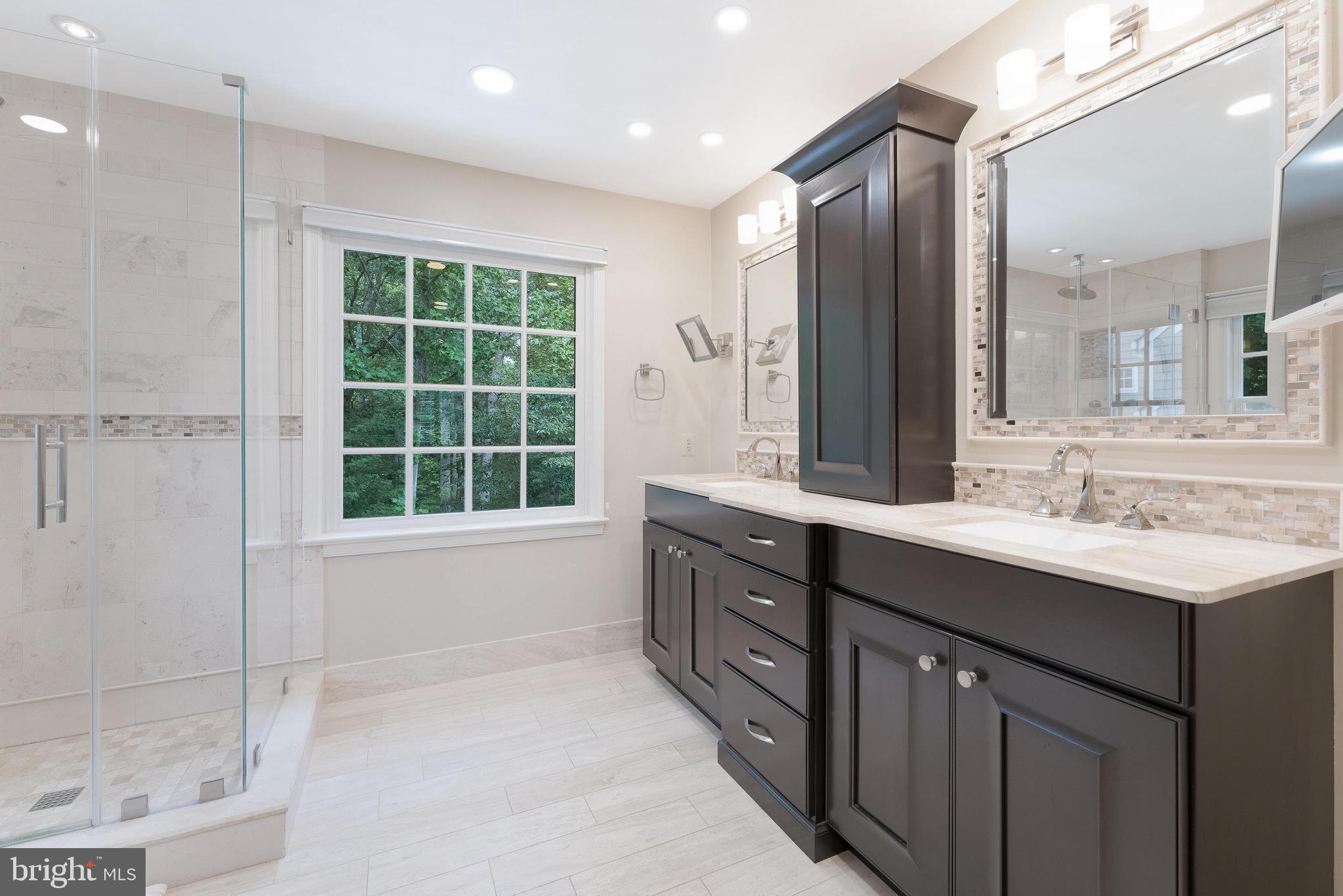 1248 Lamplighter Way Reston, VA 20194 - Photo 30 of 64 a bathroom with a sink double vanity and a mirror