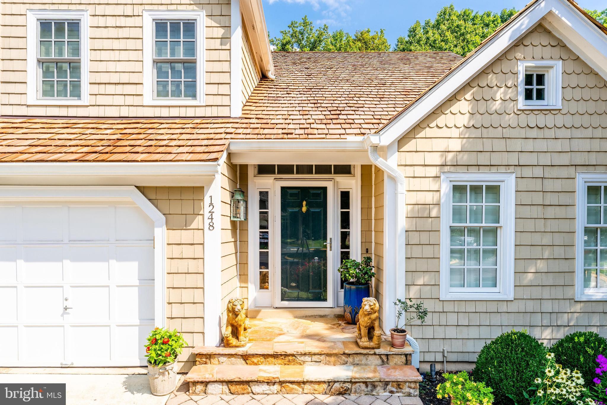 1248 Lamplighter Way Reston, VA 20194 - Photo 3 of 64 a view of a brick house with large windows and potted plants