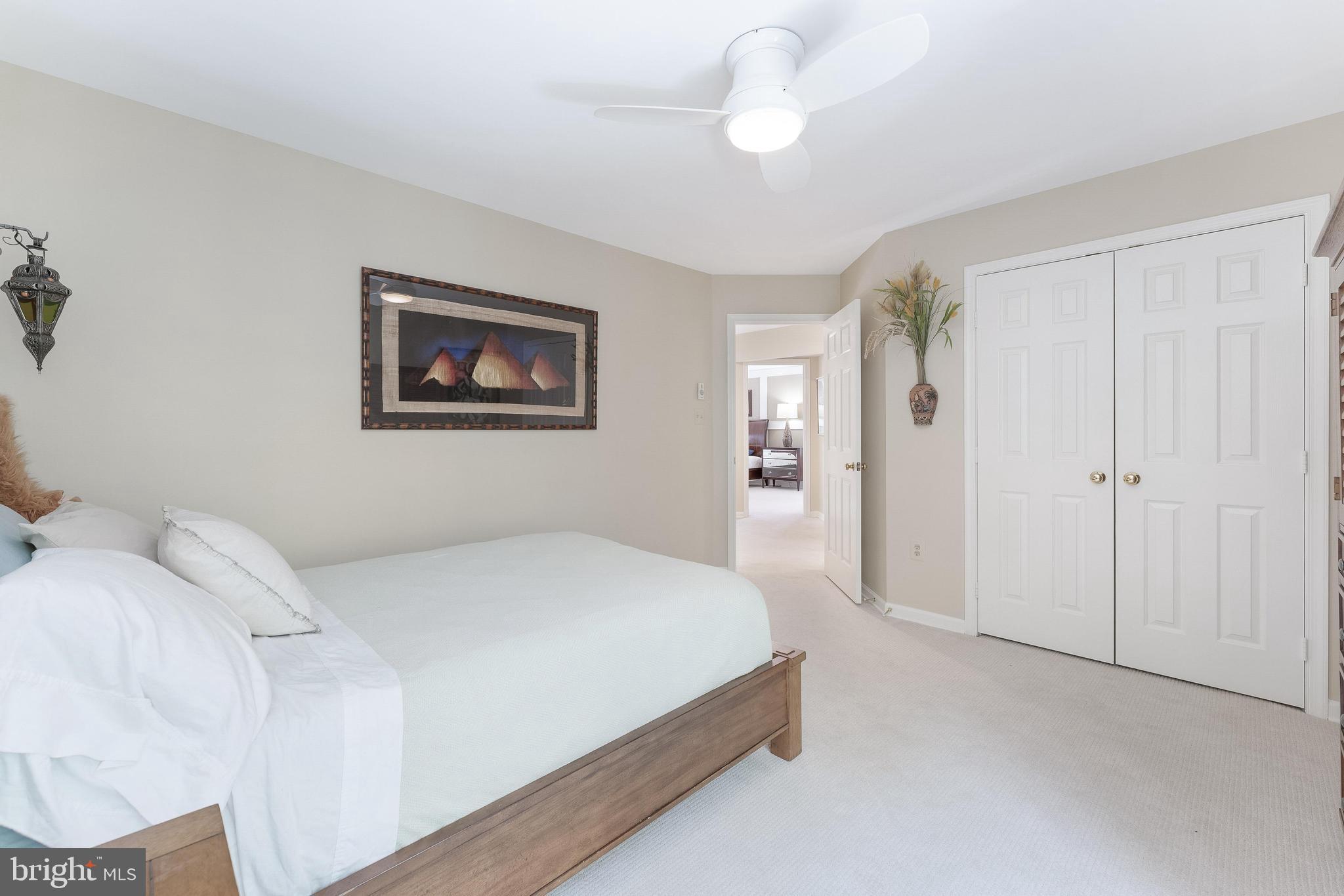 1248 Lamplighter Way Reston, VA 20194 - Photo 35 of 64 a bedroom with a large bed and a chandelier