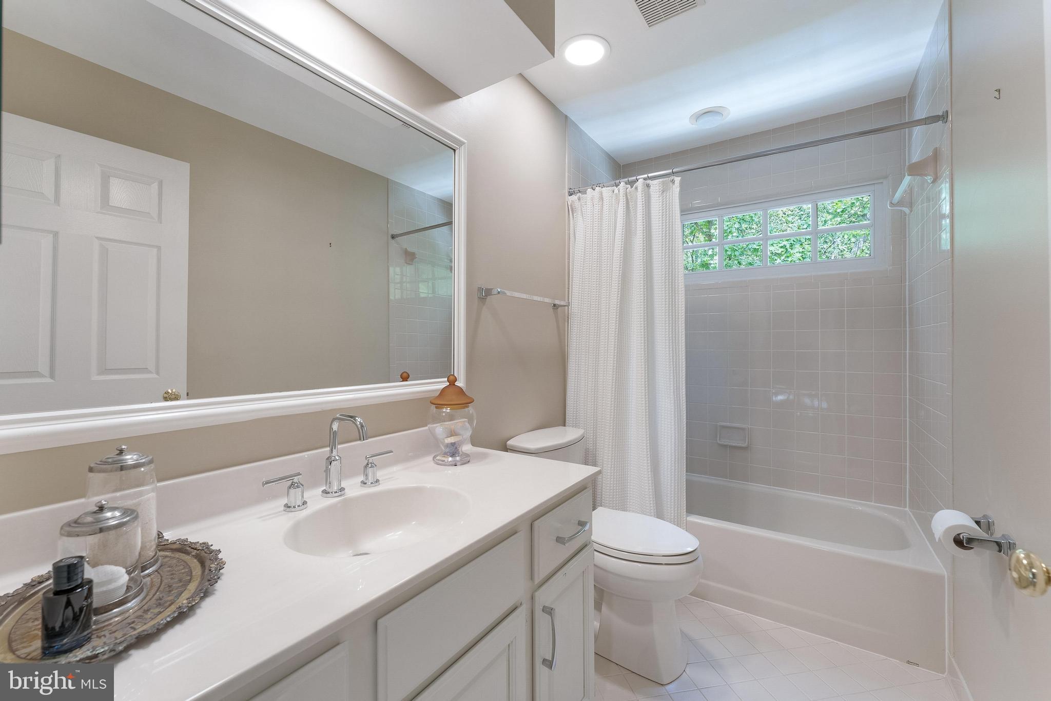 1248 Lamplighter Way Reston, VA 20194 - Photo 36 of 64 a bathroom with a sink toilet a shower and a mirror