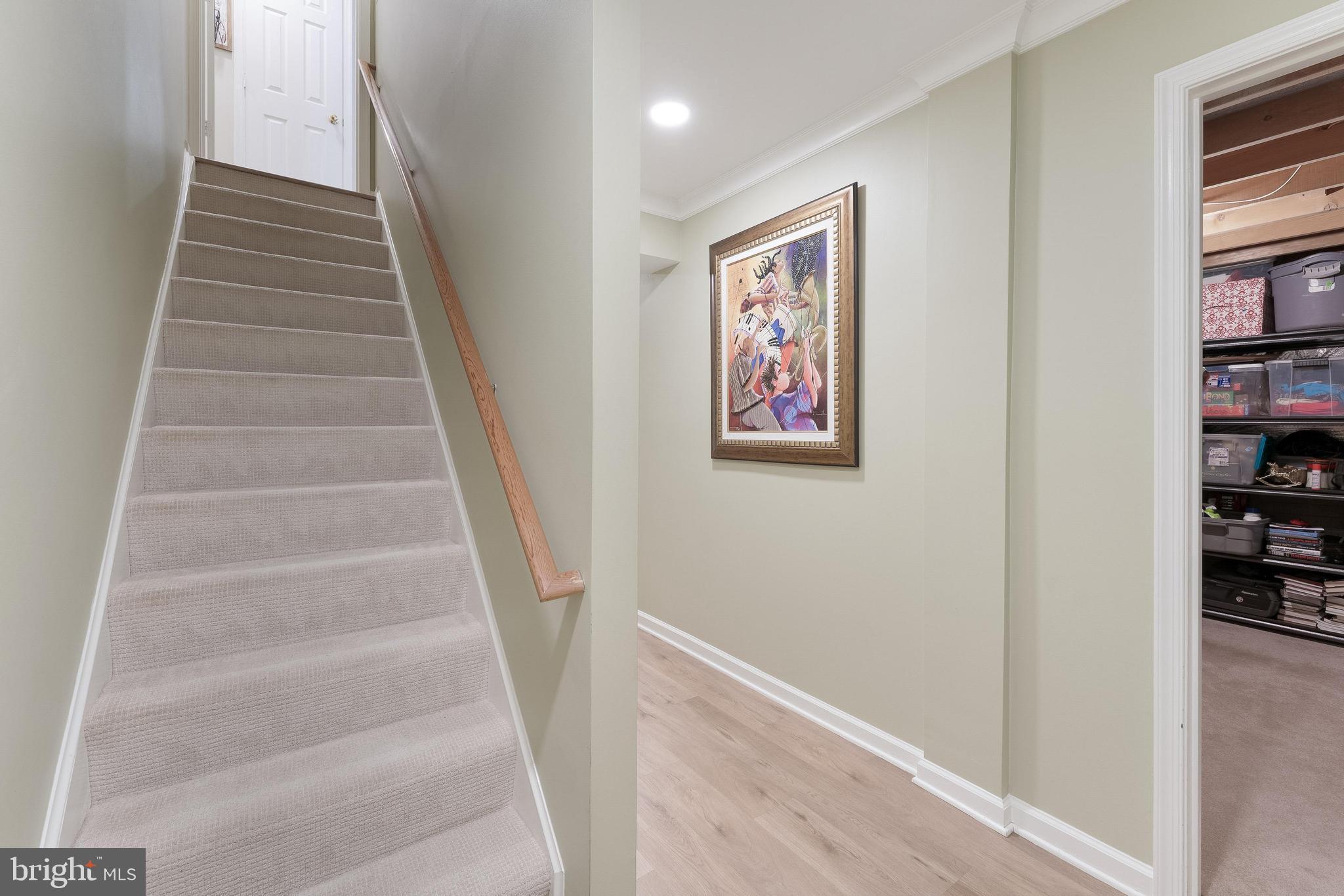 1248 Lamplighter Way Reston, VA 20194 - Photo 40 of 64 a view of staircase with wooden floor and lots of frames on wall
